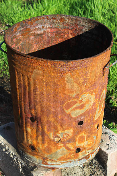 istock Image of rusty garden waste incinerator bin, on lawn grass 523872379