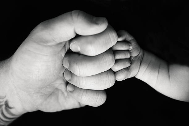 istock Father and Newborn Son Making Fists 523872808