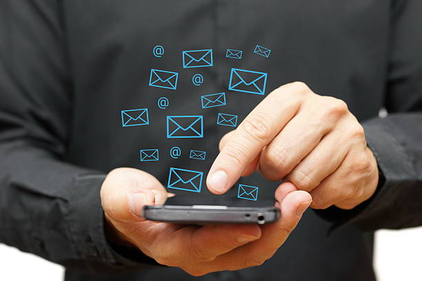 istock Businessman using smart phone with email icons around 523873051