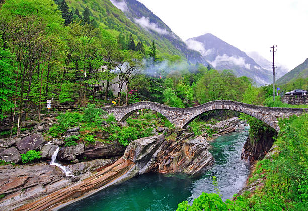 Old roman bridge Roman bridge in Vogorno, Switzerland vogorno stock pictures, royalty-free photos & images