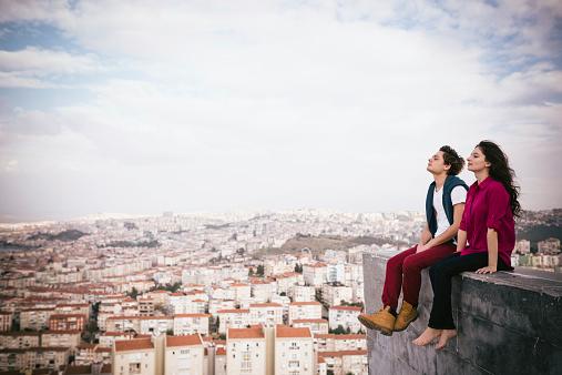 Young heterosexual couple looking in urban landscape.