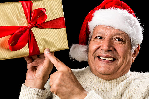 istock Excited Aged Man Pointing At Golden Gift In Hand 523874217