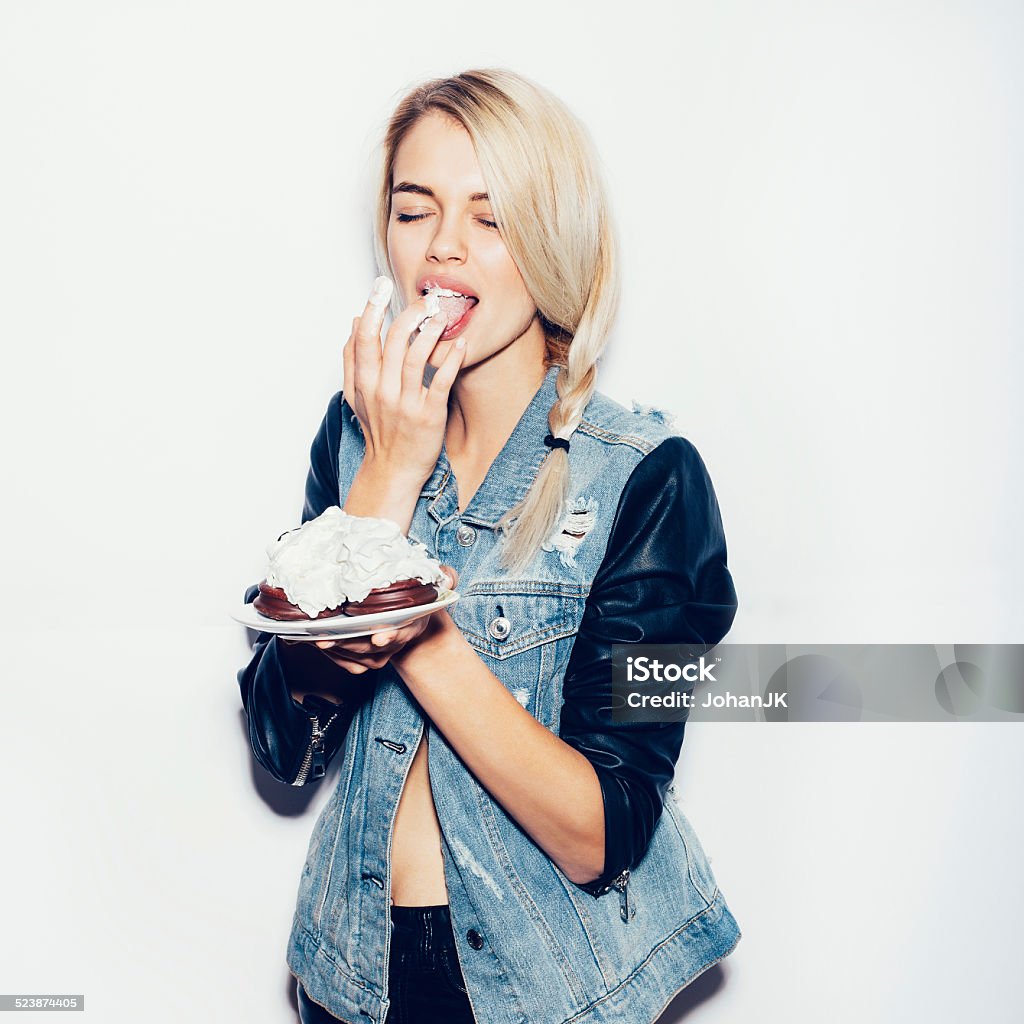 Pretty blonde girl  eating chocolate Cake Pretty blonde girl eating chocolate Cake. Indoor lifestyle portrait of woman in sunglasses.  White background, not isolated Adult Stock Photo