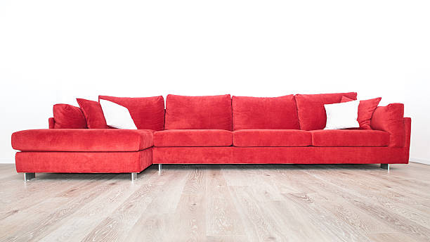 istock Red sofa and carpet on a wooden parquet floor 523874530