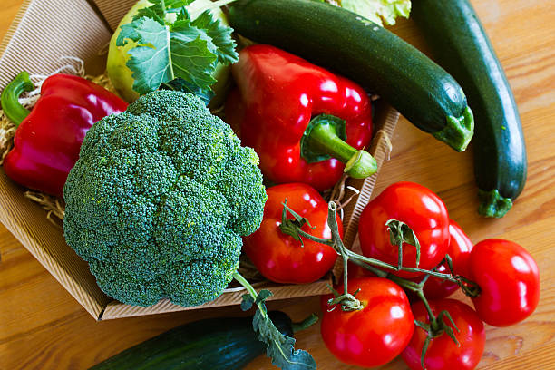 istock Basket with fresh vegetables on a wooden table 523874586