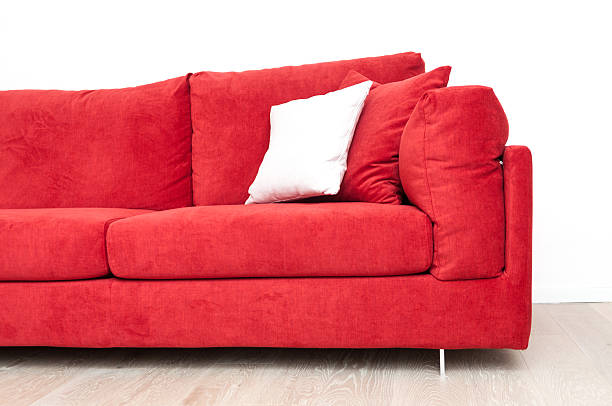 istock Red sofa and carpet on a wooden parquet floor 523874756