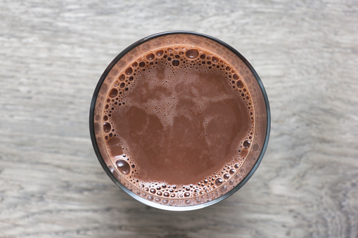 Glass of fresh chocolate milk. Directly above view. Photo is taken with dslr camera in studio.