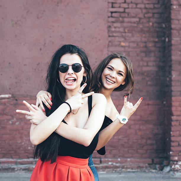 istock Two young girl friends having fun and smiling 523876073