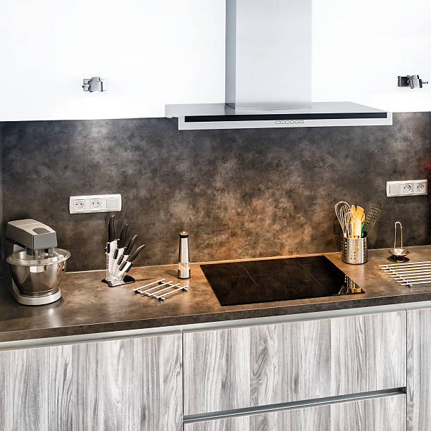 istock New modern gray kitchen with utensils next to range hood 523876382