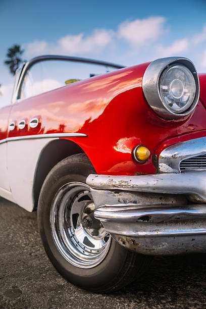 Vintage car horn hood ornament on a classic car.