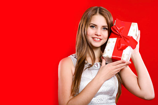 istock Beautiful girl with long hair with gift box 523876549