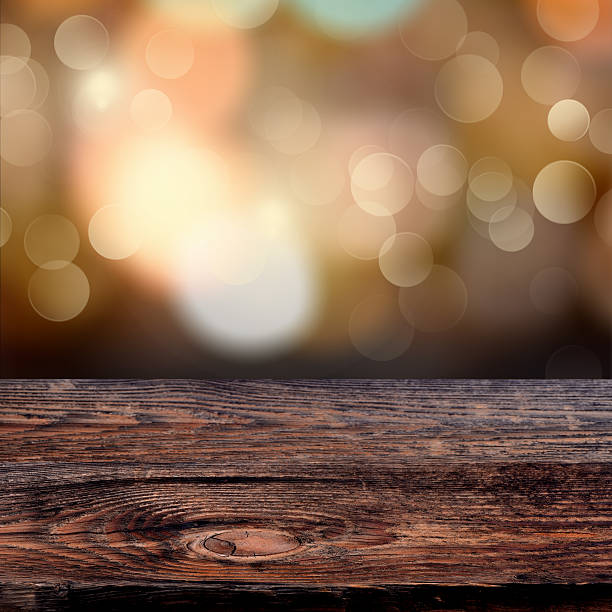 istock Old weathered wooden board with a sparkling bokeh 523877329
