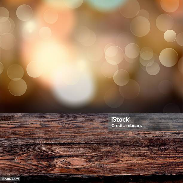 Old Weathered Wooden Board With A Sparkling Bokeh Stock Photo - Download Image Now - Backgrounds, Bright, Brown