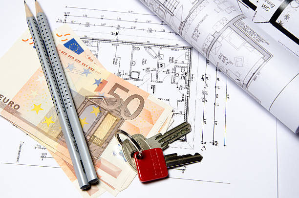 istock Floor plan with 50 euro bills, pencils and rolled-in plans 523877843
