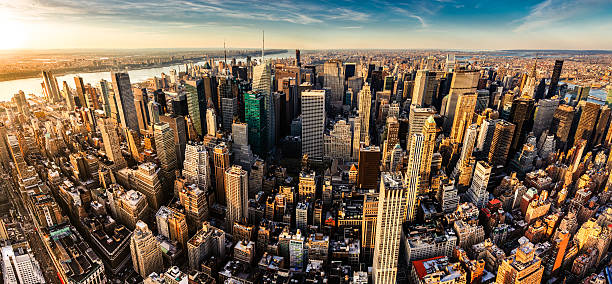New York City Panoramic Aerial View Panoramic aerial view of Midtown Manhattan at sunset. New York City. roosevelt island stock pictures, royalty-free photos & images