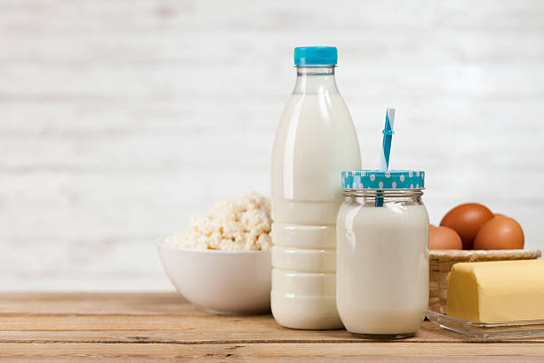 istock Milk bottle on wooden table 523880224
