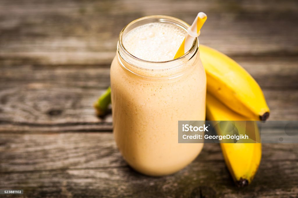 Fresh banana shake Banana milkshake on wooden table Banana Stock Photo