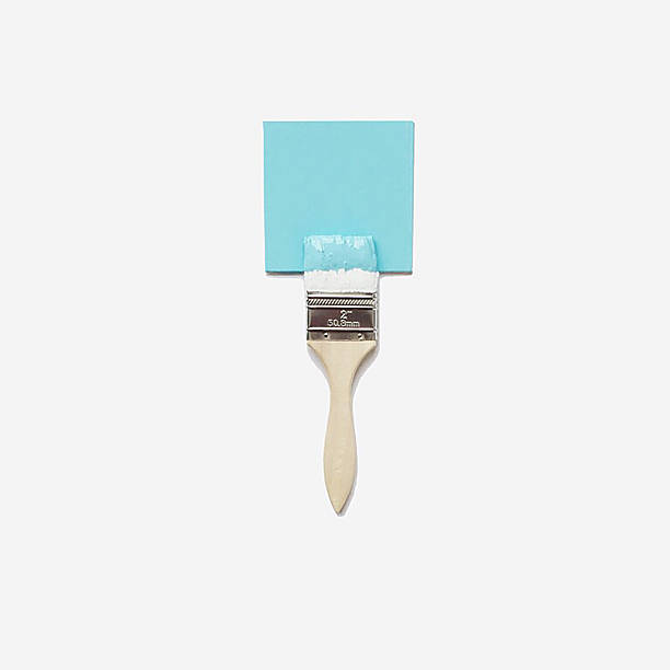 Paintbrush resting on a blue paint can, symbolizing diy renovation projects