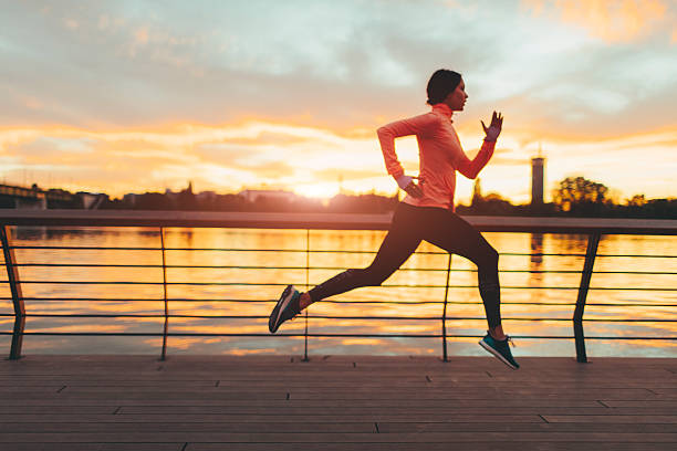 istock Young Woman Jogging Near River. 523882044