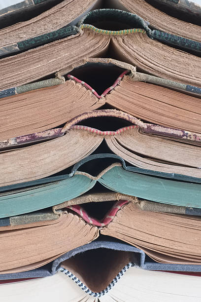 istock Old books stacked close-up, detail, vertical composition 523882682