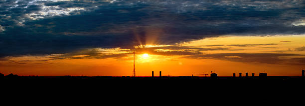 istock Panorama colorful sunset - silhouettes buildings 523882720
