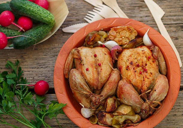 istock Two small whole chicken baked with onions, apples, garlic 523884180
