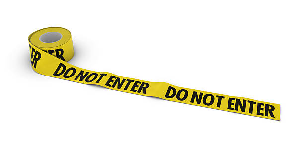 istock Do no enter Tape Roll unrolled across white floor 523884728