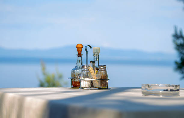table and chairs on the beach cafe, terrace cafe with tablecloth,cafe and sea view in Greece, Cafe at the seaside