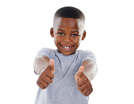 Studio shot of a cute little boy  giving you thumbs up against a white background
