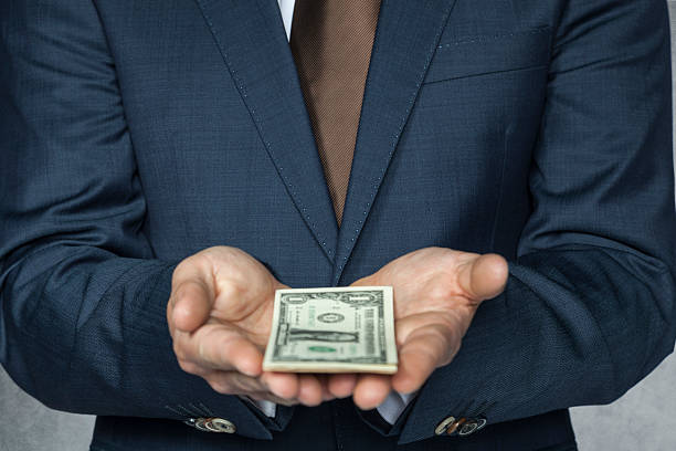 istock businessman with money on hand 523894697
