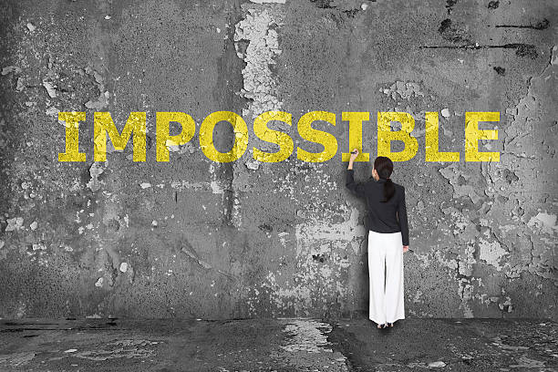 istock business woman drawing impossible on wall 523895433