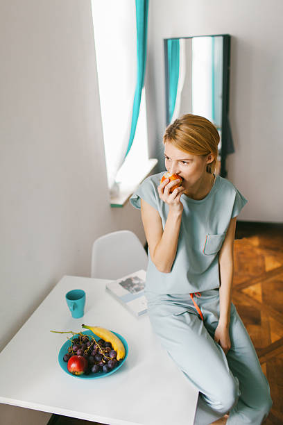 istock Girl eating apple 523895475