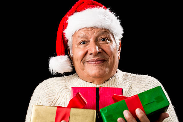 istock Puzzled Old Gentleman Carrying Three Wrapped Gifts 523895541