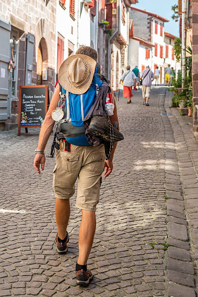 Pilgrim on the Camino de Compostela Saint-Jean-Pied-de-Port, France - September 12, 2014: A pilgrim on his way to do the Pilgrimage to Santiago de Compostela in Spain that takes about 800 kilometer of hiking. saint jean pied de port stock pictures, royalty-free photos & images