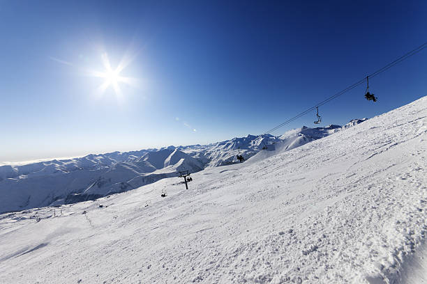 istock Off-piste slope and blue sky with sun 523896873