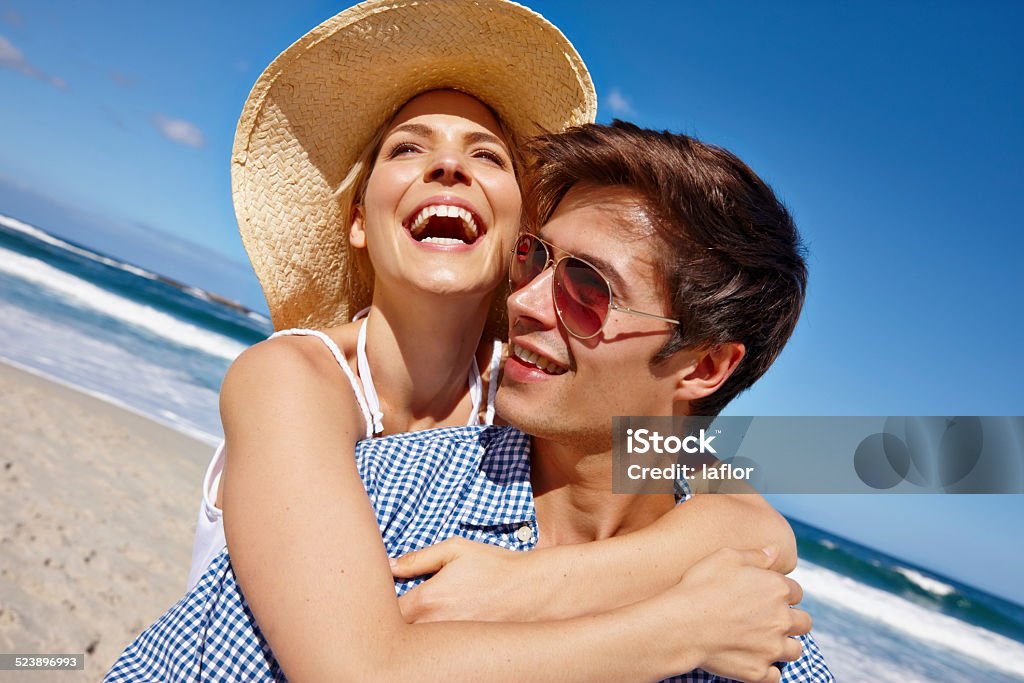 You can never have too much beach Shot of a happy young couple enjoying a day at the beach Adult Stock Photo