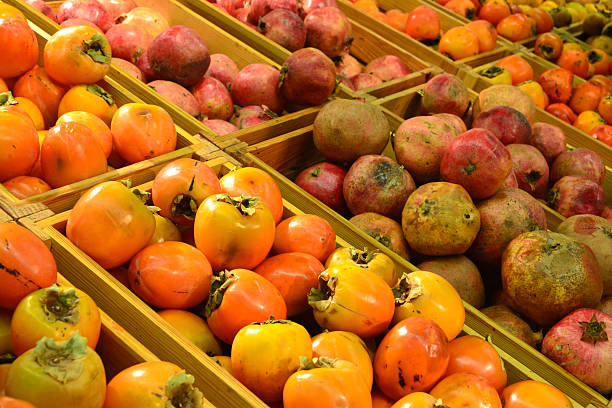 istock Persimmon and pomegranate in grocery store 523897081