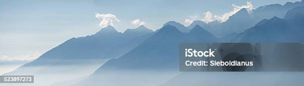 South Tyrol Misty Mountain Peaks Panoramic Image Stock Photo - Download Image Now - Alto Adige - Italy, Blue, Copy Space