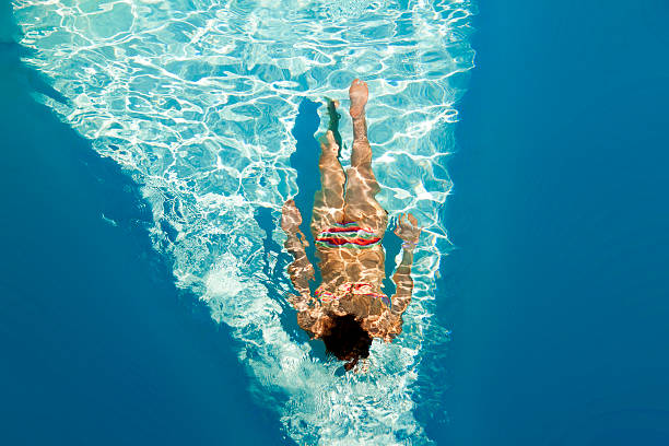 istock Girl swimming in pool under water 523897815