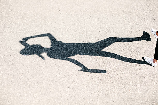 istock Shadow of girl in hat with bottle walking 523898943