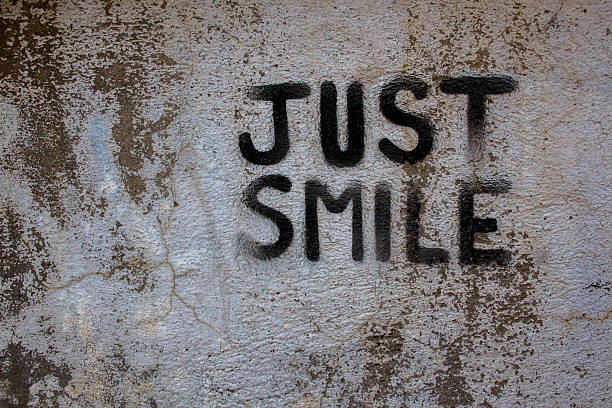 istock Just Smile graffiti on a concrete wall 523900157