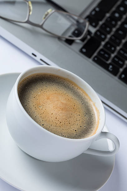 istock Cup of coffee with a keyboard 523917067