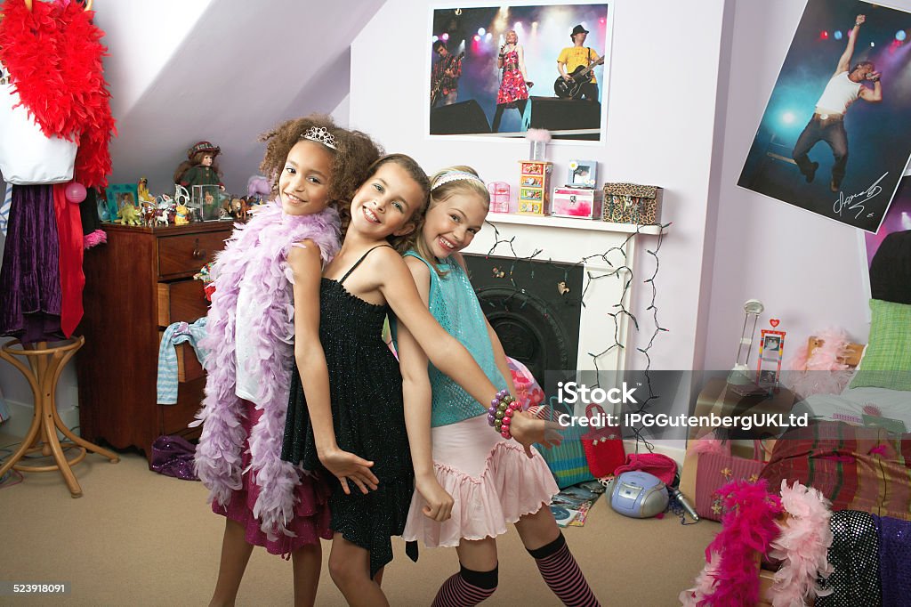 Girls In Trendy Bedroom At Slumber Party Happy young girls striking a pose in trendy bedroom at slumber Party 10-11 Years Stock Photo