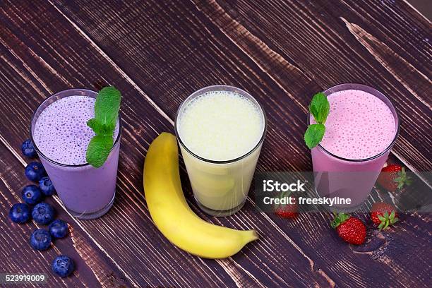 Strawberry Banana And Blueberries Milkshakes Stock Photo - Download Image Now - Blueberry, Breakfast, Cocktail