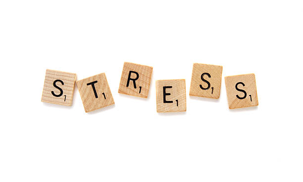 West Palm Beach, USA - November 7, 2013: Scrabble game letter tiles spelling out the word STRESS.  Scrabble is a crossword strategy board game distributed by Hasbro.