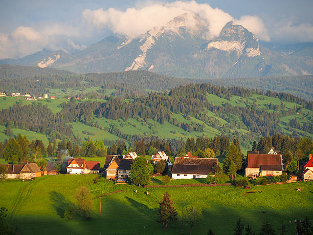 istock Summer sunrise mountain village outskirts view and Tatra range b 523919421