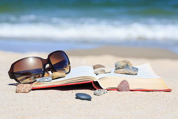 istock Book and sun glasses on the beach 523919541