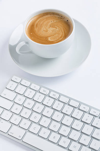 istock Cup of coffee with a keyboard 523921705