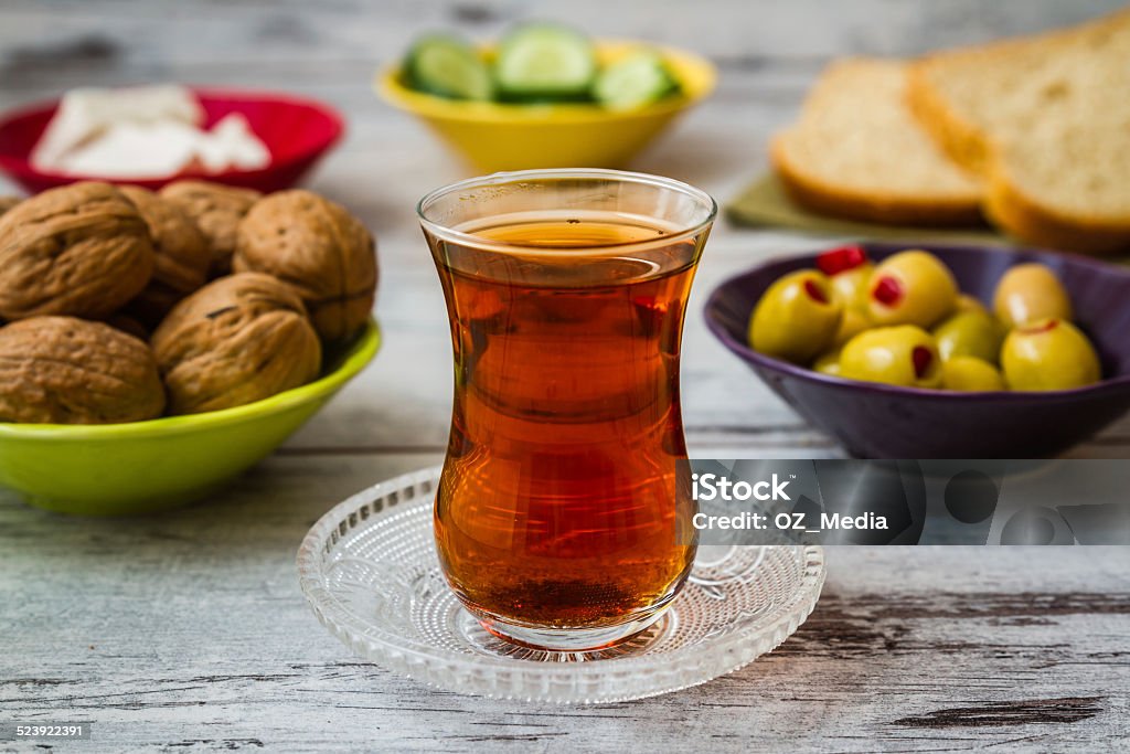 Healthy Breakfast with Tea Healthy breakfast including tea, breads, cucumbers, olives, cheese and hazelnuts Balance Stock Photo