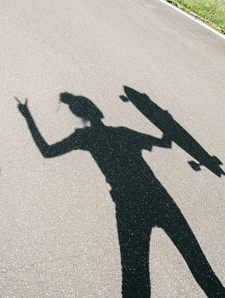 istock Shadow of young woman posing with skateboard 523922461
